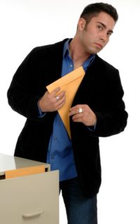 Image of a man slipping a manila envelope into his coat