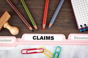 file folder with the word "claims" on it
