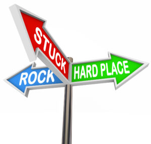 Road signs with Rock and Hard Place with Stuck in between them