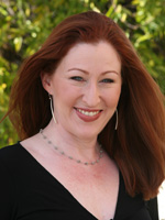 White woman with long red hair wearing black