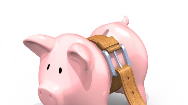 Image of a pink piggy bank with a brown belt tightened around its waist