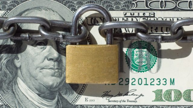 American money locked with padlock
