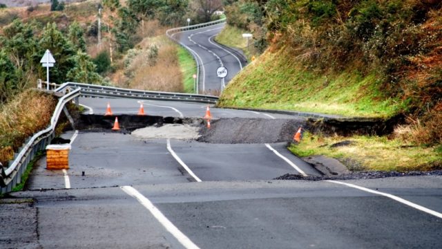 A stretch of roadway where an entire section has collapsed